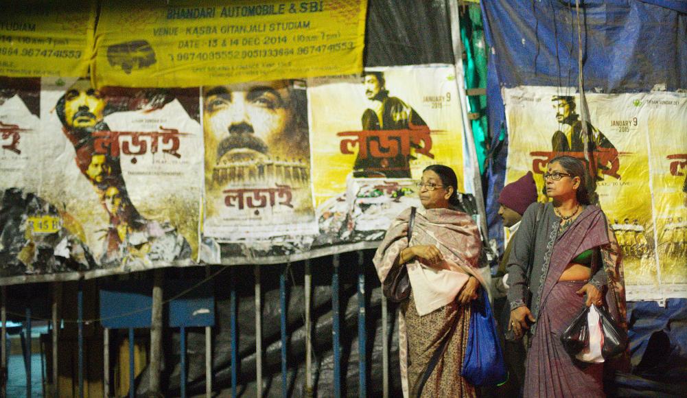 Two women and all the posters looking off screen