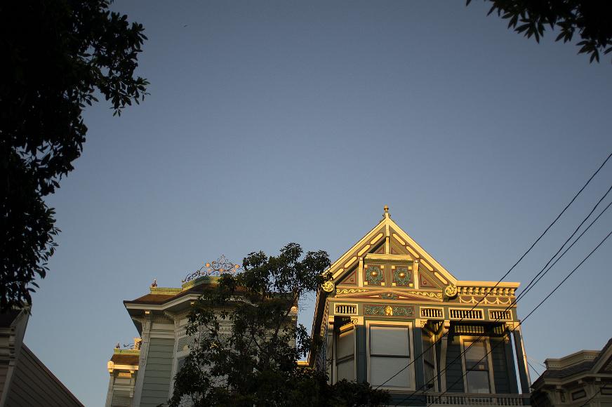 Golden Glow Houses The day's last light falls on two ornately painted Victorians in the Lower Haight of San Francisco