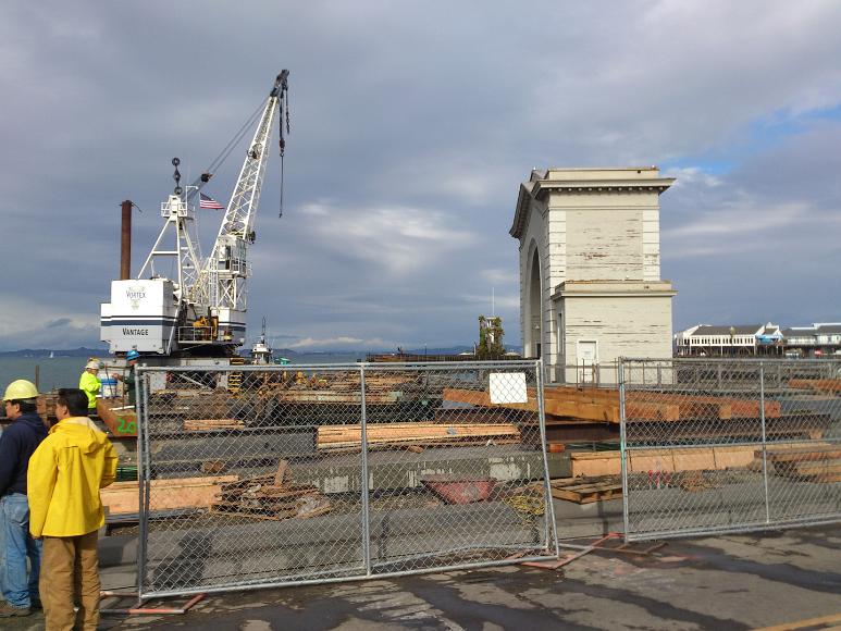 Work being done at Pier 41, SF A vantage vortex crane sits next to an arch at a construction site at Pier 41 in the early winter of 2012 with workers present in hard hats and without