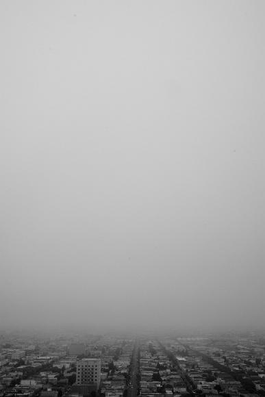 Foggy city from Bernal Heights Gray fog covers most of a San Francisco city scene as seen from above with rows of streets and buildings only visible in the lower eighth of the image