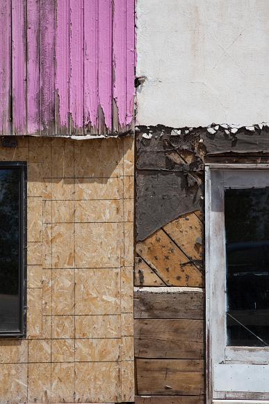 Old building detail with plywood and pink painted slats