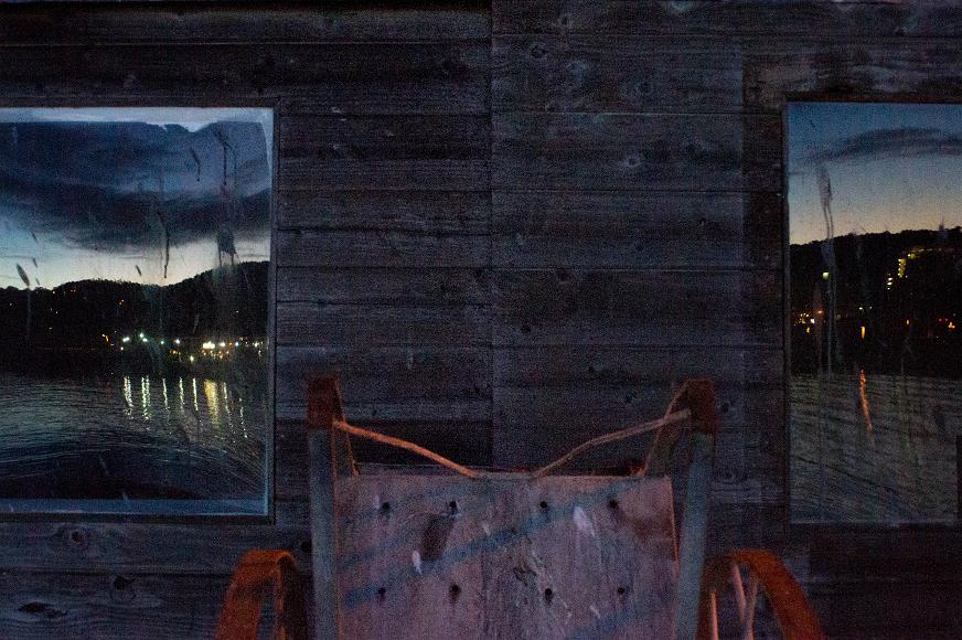 Reflections on the pier Night lights and Monterrey Bay reflect in the windows of a