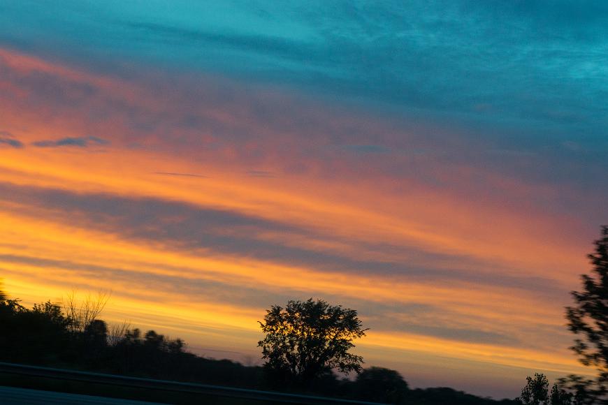 Clouds from the car Sunset lit orange clouds as seen froma car in Kansas at 75 miles per hour