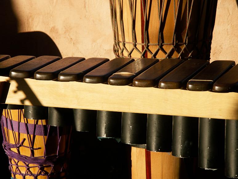 Two drums and a xylophone, before the start of the fundraiser for Dane at Shona Sol, Cerrillos, New Mexico A drum on the left underneath a xylophone which is in the middle of the pictures and another drum on the left hand side above the xylophone