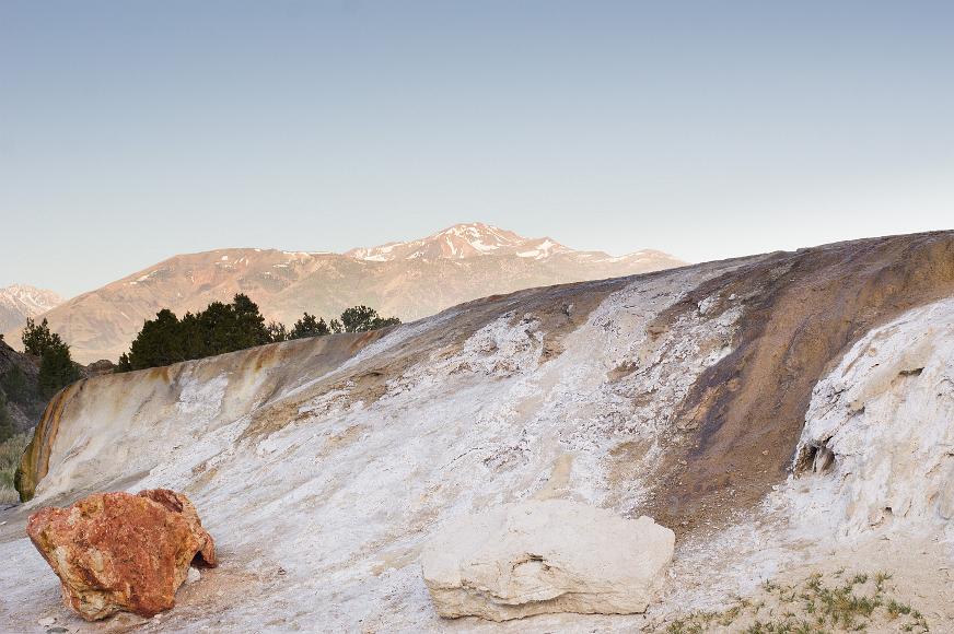 Eastern Sierra Hot Springs Accretions of hot springs in front of desert mountains capped with snow on the Nevada California border
