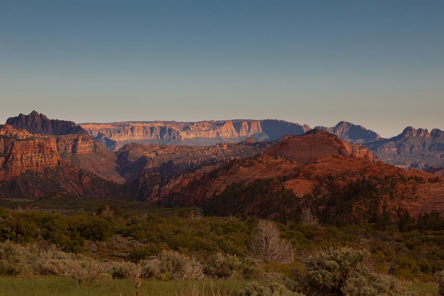 Sandstone peaks trees and a meadow near Zion Park in Utah