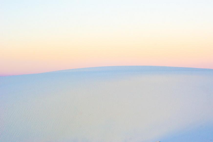 White Sands 2012 08 White and light blue gypsum sand dunes underneath a pink, and orange, and purple dusk sky in White Sands National Monument in New Mexico
