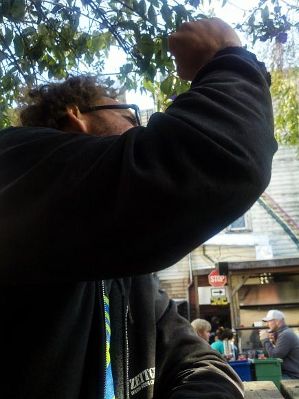 Raise your hands up in the air, raise your hands up in the air A man raises his fist to emphasize a point on the patio of Zeitgeist Bar and sometimes Grill.