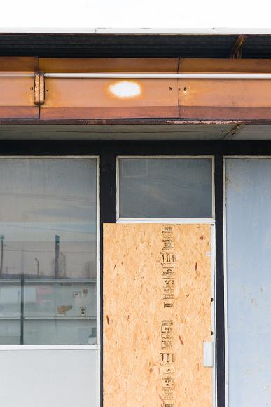 Boarded up with plywood, Abandoned gas station detail #6