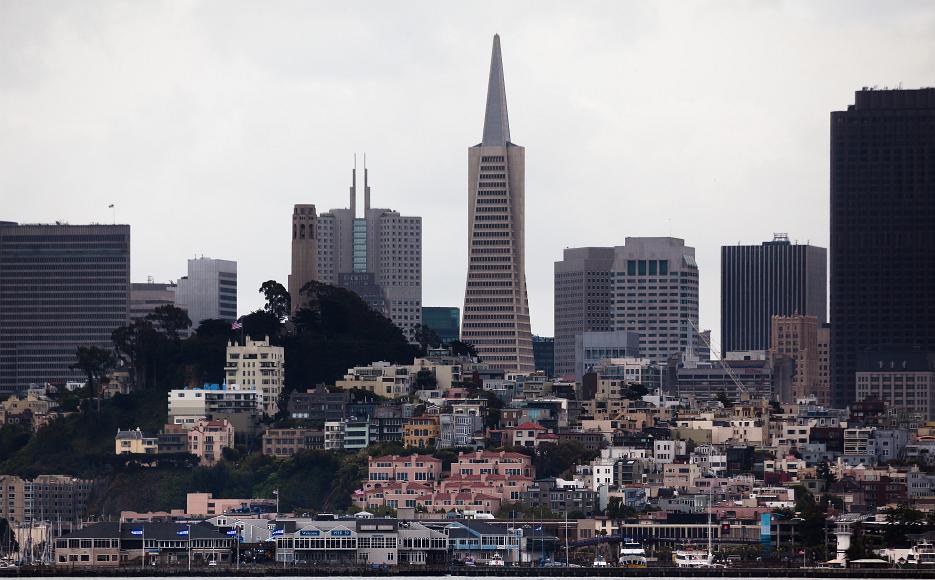 Nob Hill and downtown San Francisco from on the water on a cloudy day View of the city of San Francisco from a ferry in the SF Bay with very flat light and muted colors and the buildings of Nob Hill and Coit Tower visible in the...