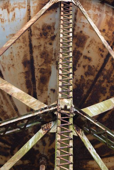 Rusty old water tank on Alcatraz Rusted green and white metal girders support the large rusting water tank which fills the background
