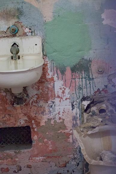 Colorful cell at Alcatraz multicolored painted cell wall and broken toilet and dirty sink in an inmates cell in Alcatraz Island