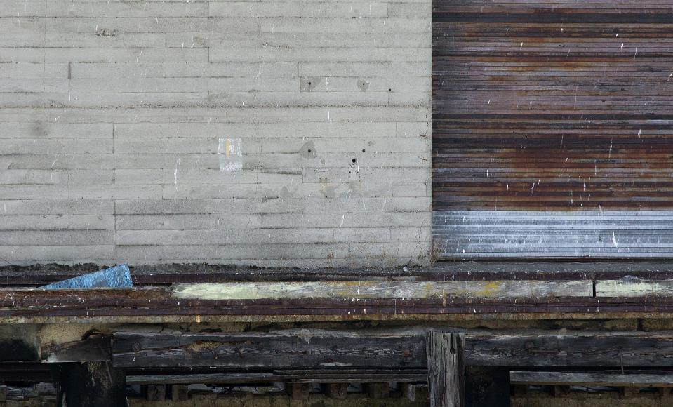 San Francisco Pier Detail #1 pier with concrete wall and corrugated metal door with crumbling wooden and metal dock below