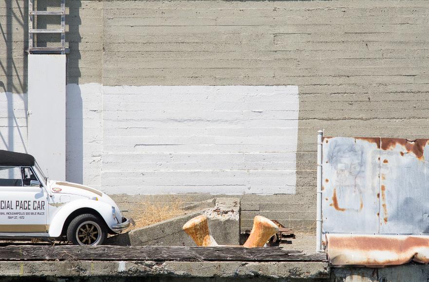 San Francisco Pier Detail #6 Volkwagon bug official pace car indianapolis 500 mile race may 27, 1972 with rusted metal wall with graffiti, concrete wall with some white paint and a ladder...